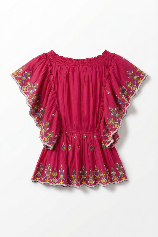 Pink top with floral embroidery on a white background