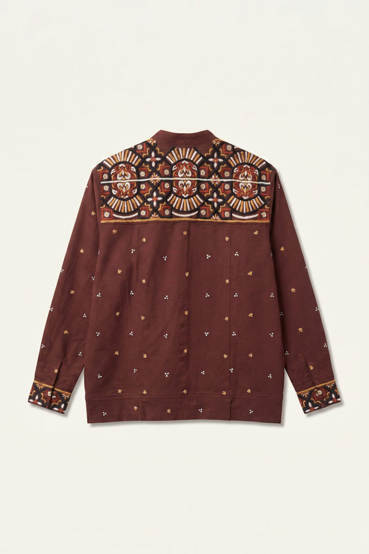 Maroon shirt with intricate patterns on a beige background