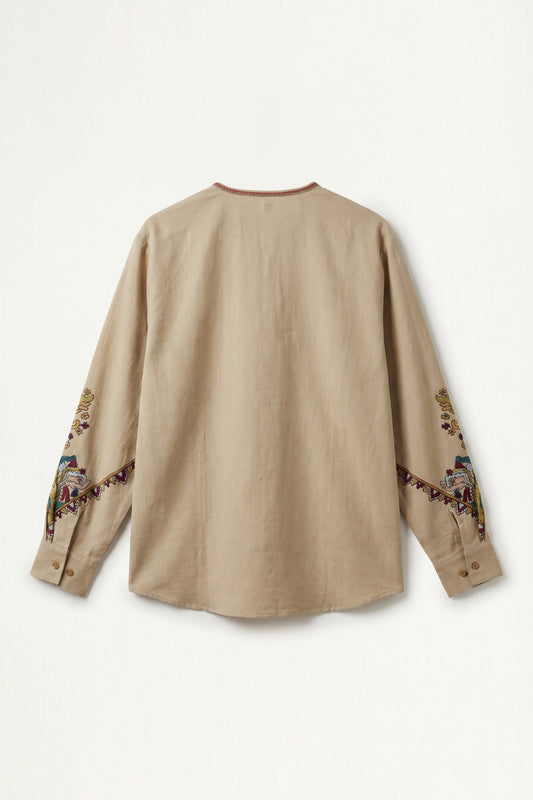 Beige long-sleeve shirt with embroidery on sleeves against a white background