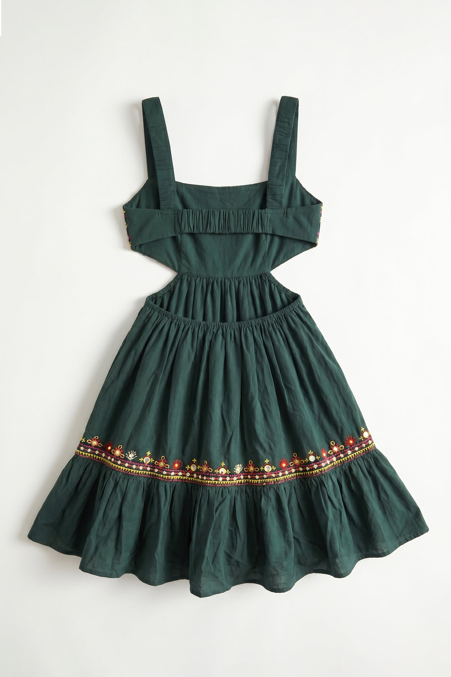 Green dress with decorative hem on a white background