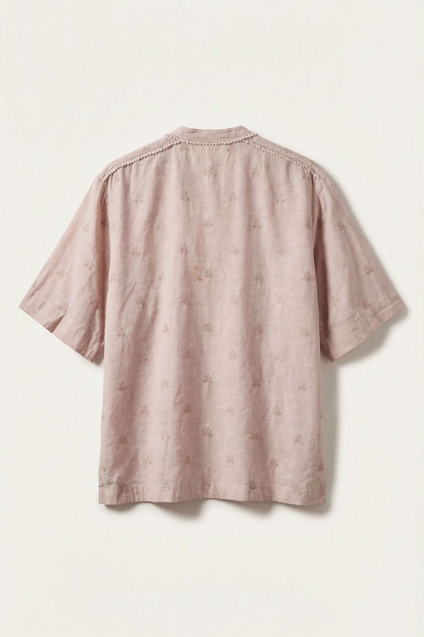 Pink textured shirt on a light beige background