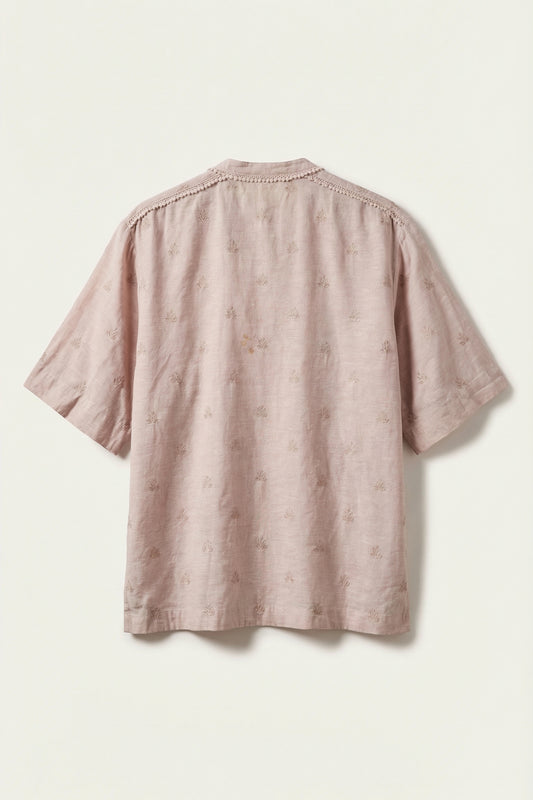 Pink textured shirt on a light beige background