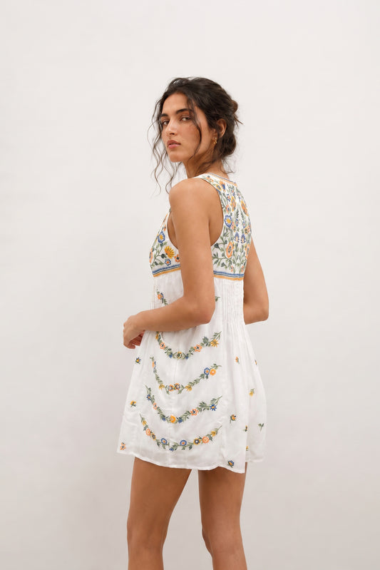 Short white romper for ladies with floral embroidery.