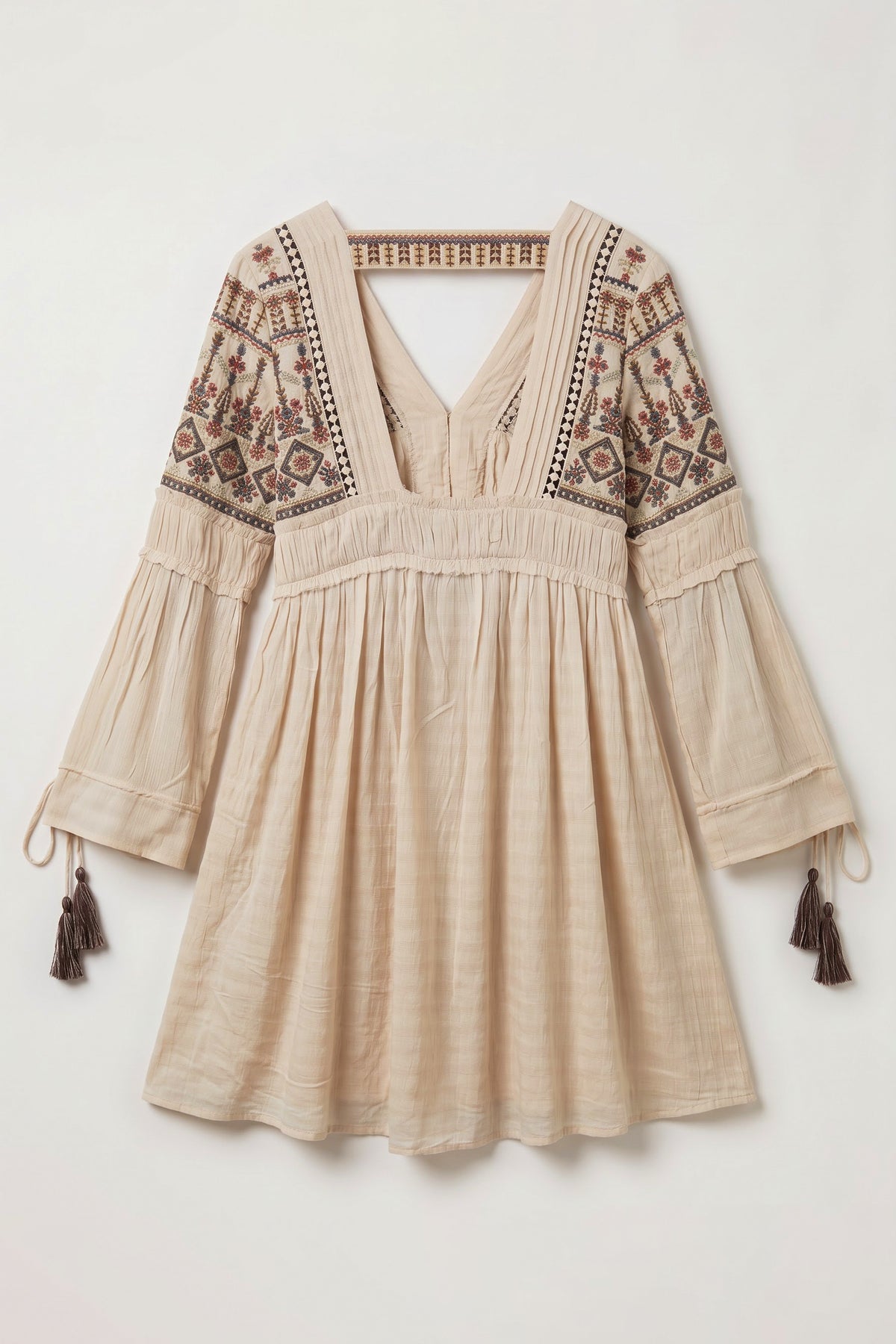 Back view of Eleanor peach mini dress featuring embroidered shoulders, a deep square back, viscose georgette dobby fabric and tassel sleeve details