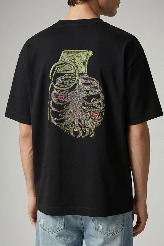 Black t-shirt with a graphic design on the back, worn by a person.