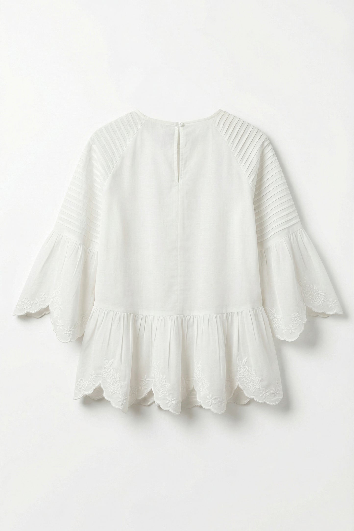 White blouse with ruffled details on a white background