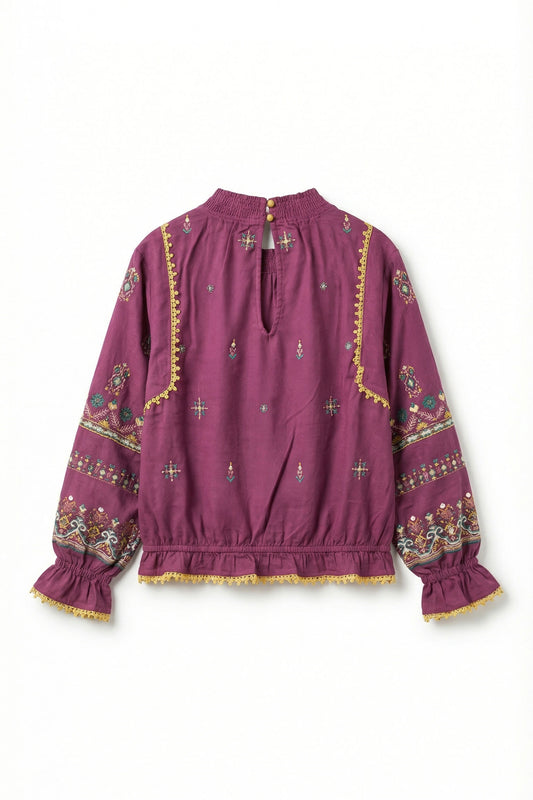 Purple blouse with intricate patterns on a white background