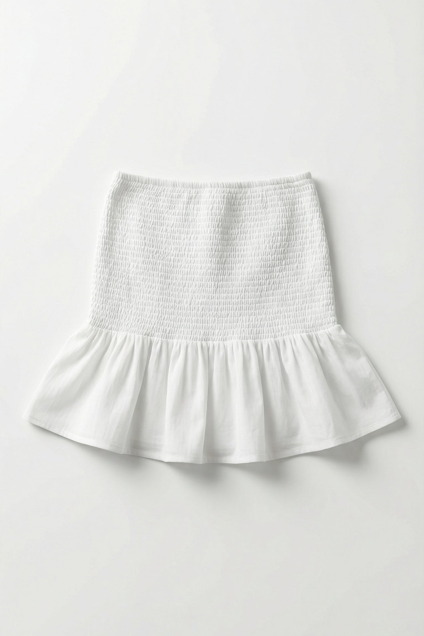 White skirt with smocked waistband on a white background