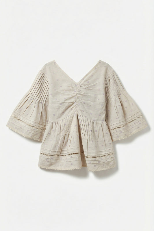 Beige blouse with ruched details on a white background