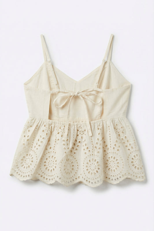 Beige lace top with thin straps on a light gray background