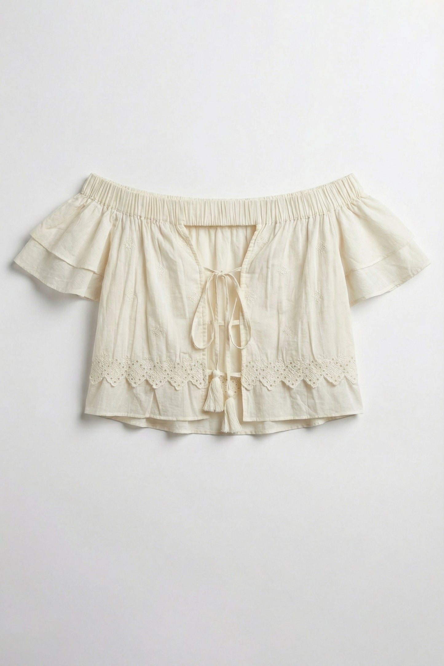 Beige shorts with ruffled details on a light gray background