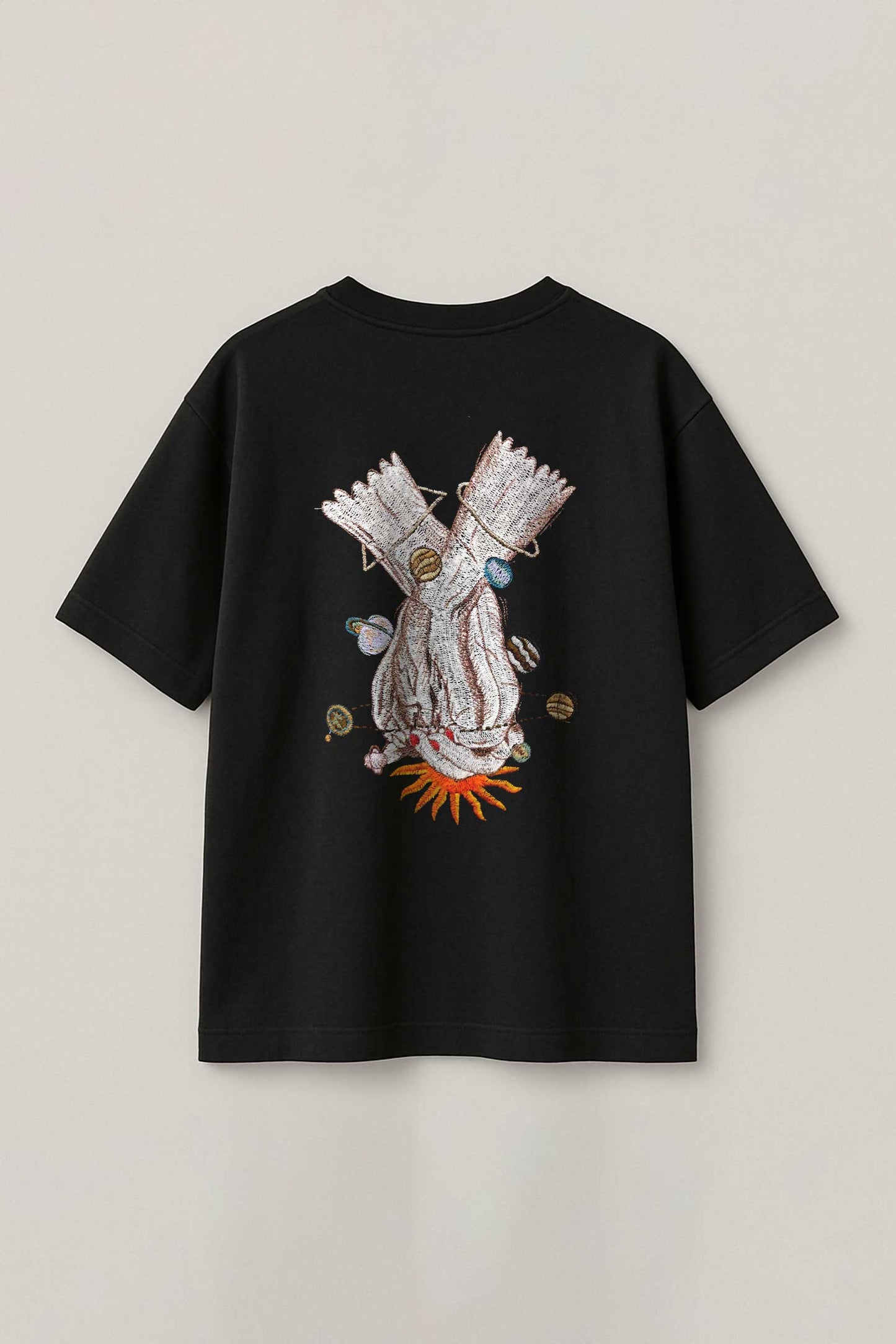 Black t-shirt with a unique design on a light gray background