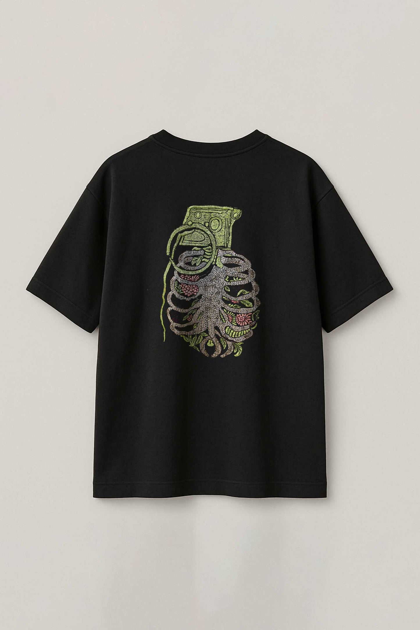 Black t-shirt with a graphic design on the back against a light gray background