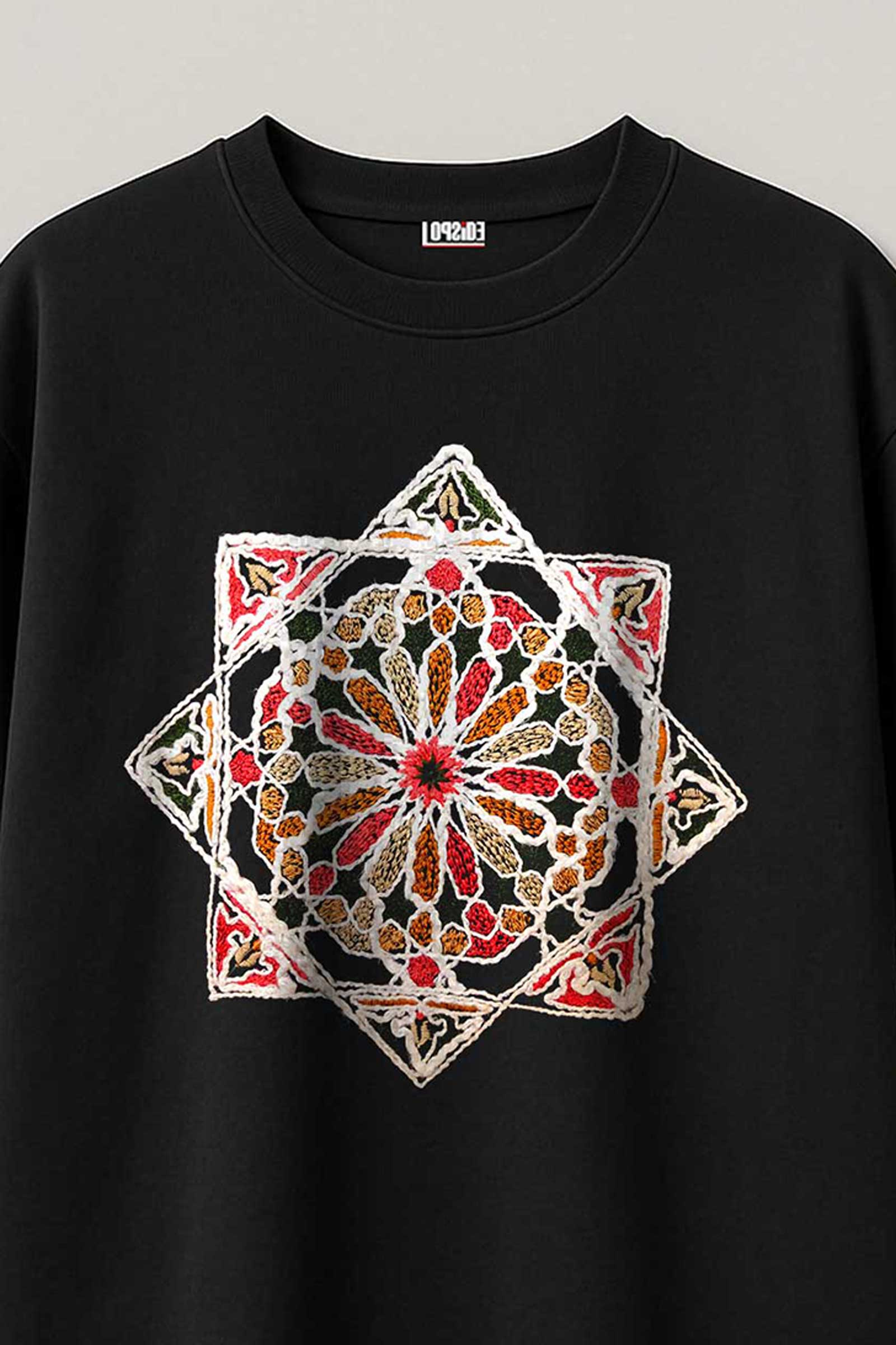 Black sweatshirt with a colorful geometric pattern on a gray background