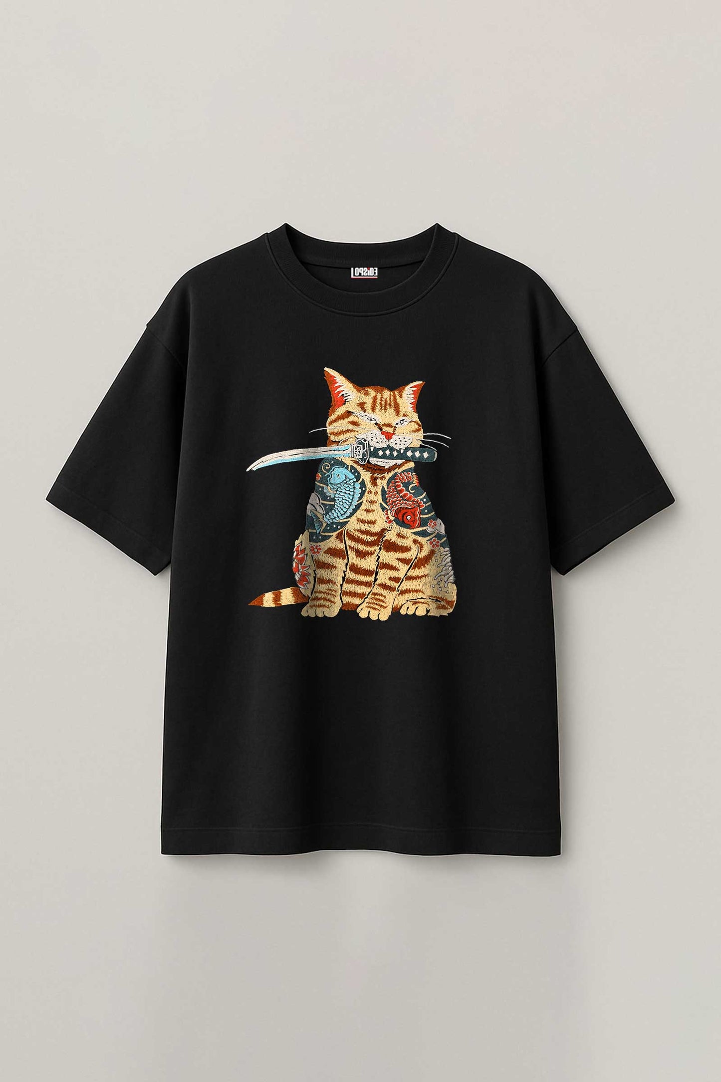 Black t-shirt with a cat graphic design on a light gray background