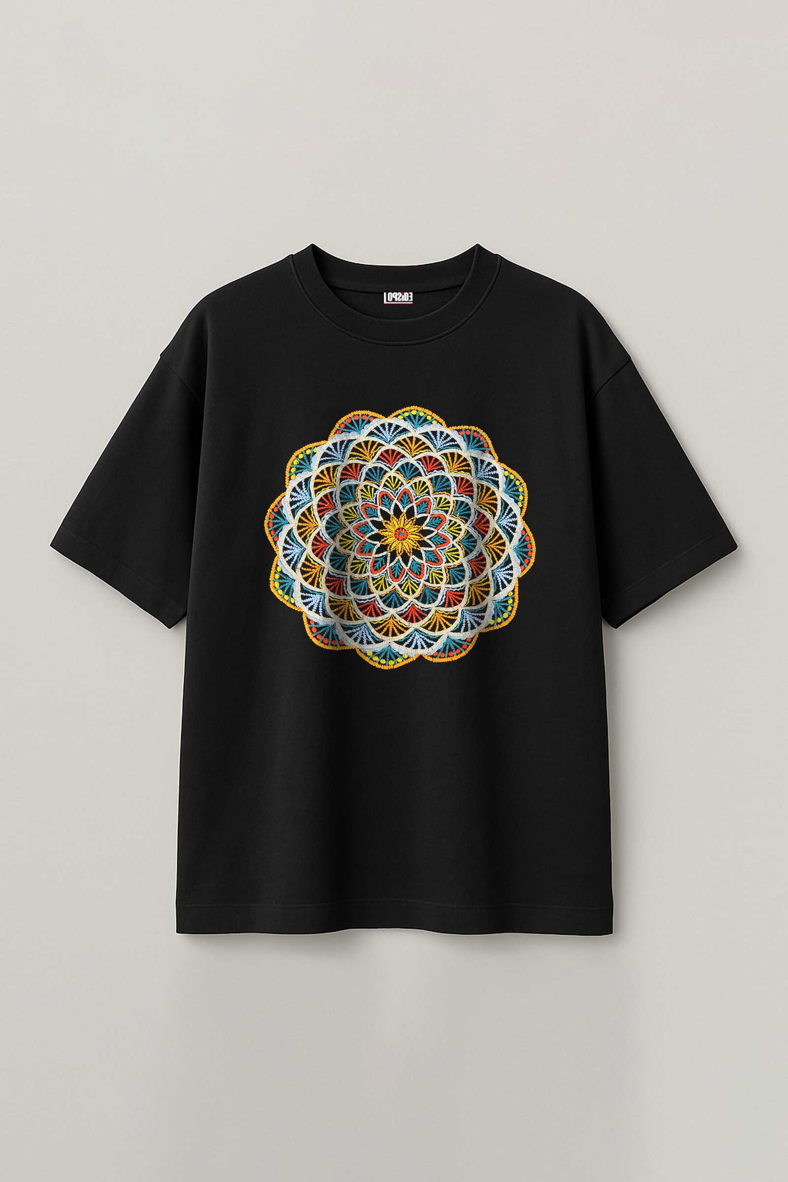Black t-shirt with a colorful mandala embroidery design on a light gray background