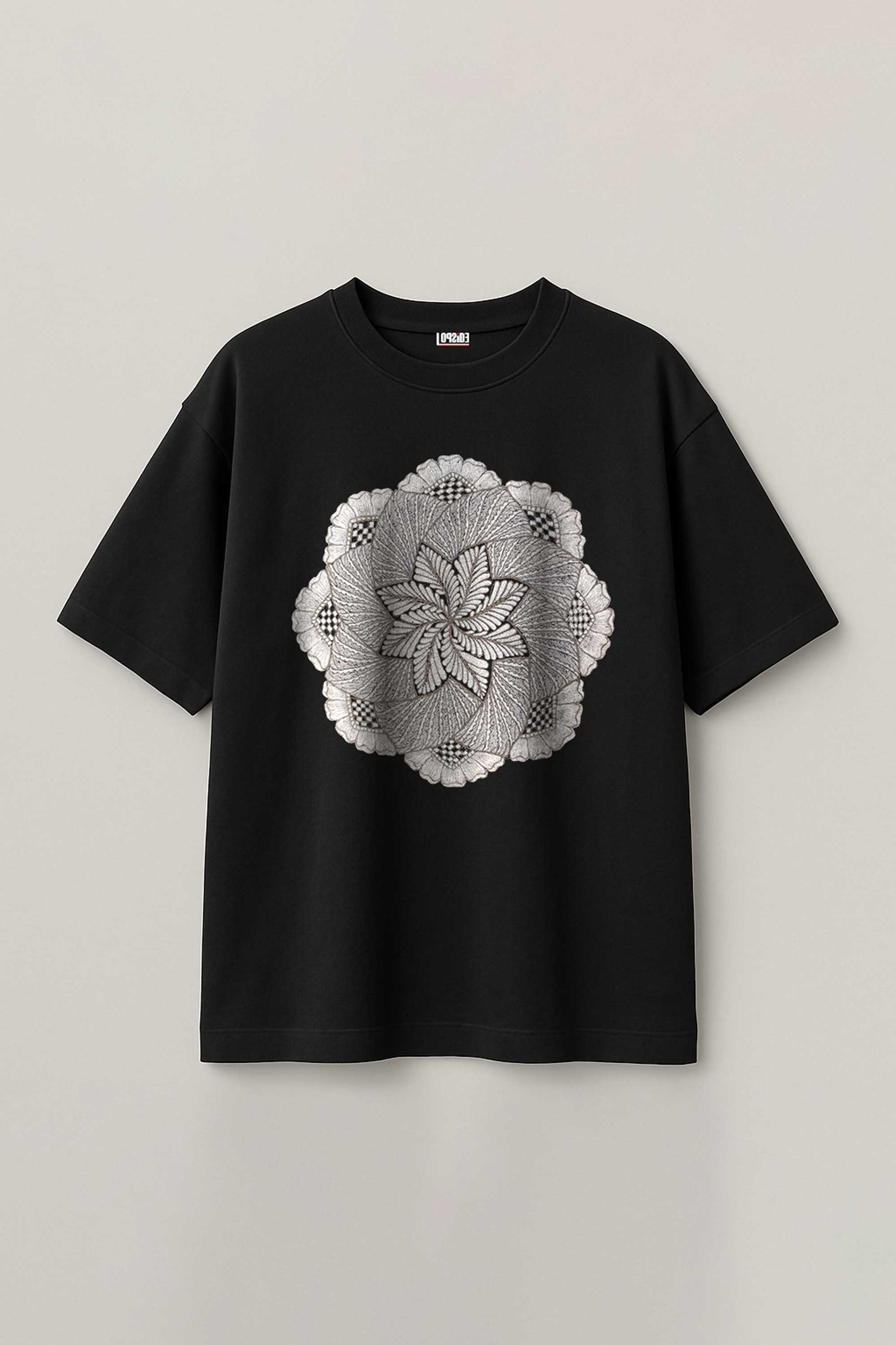 Black t-shirt with a white floral design on a light gray background