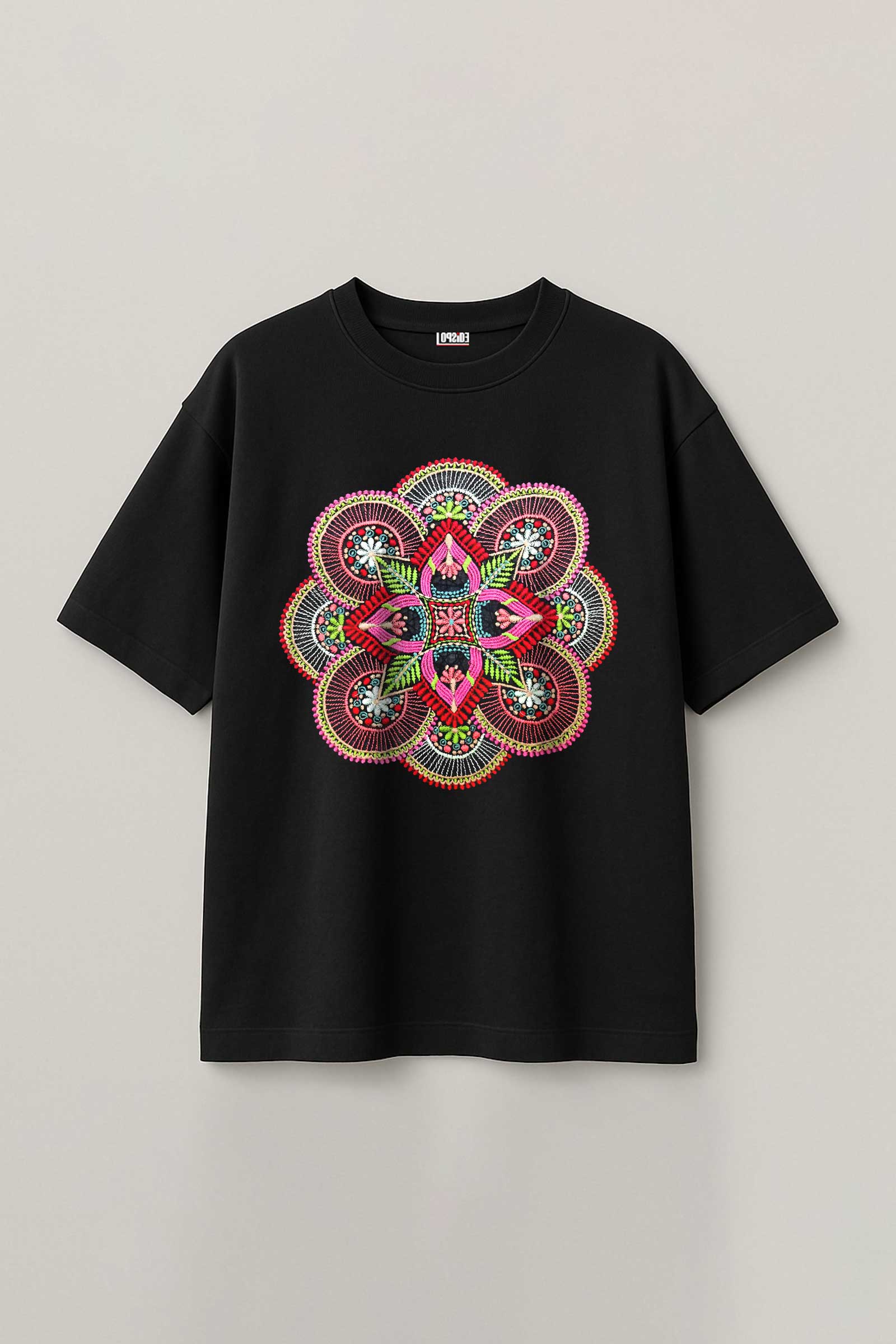 Black t-shirt with a colorful mandala design on a light gray background