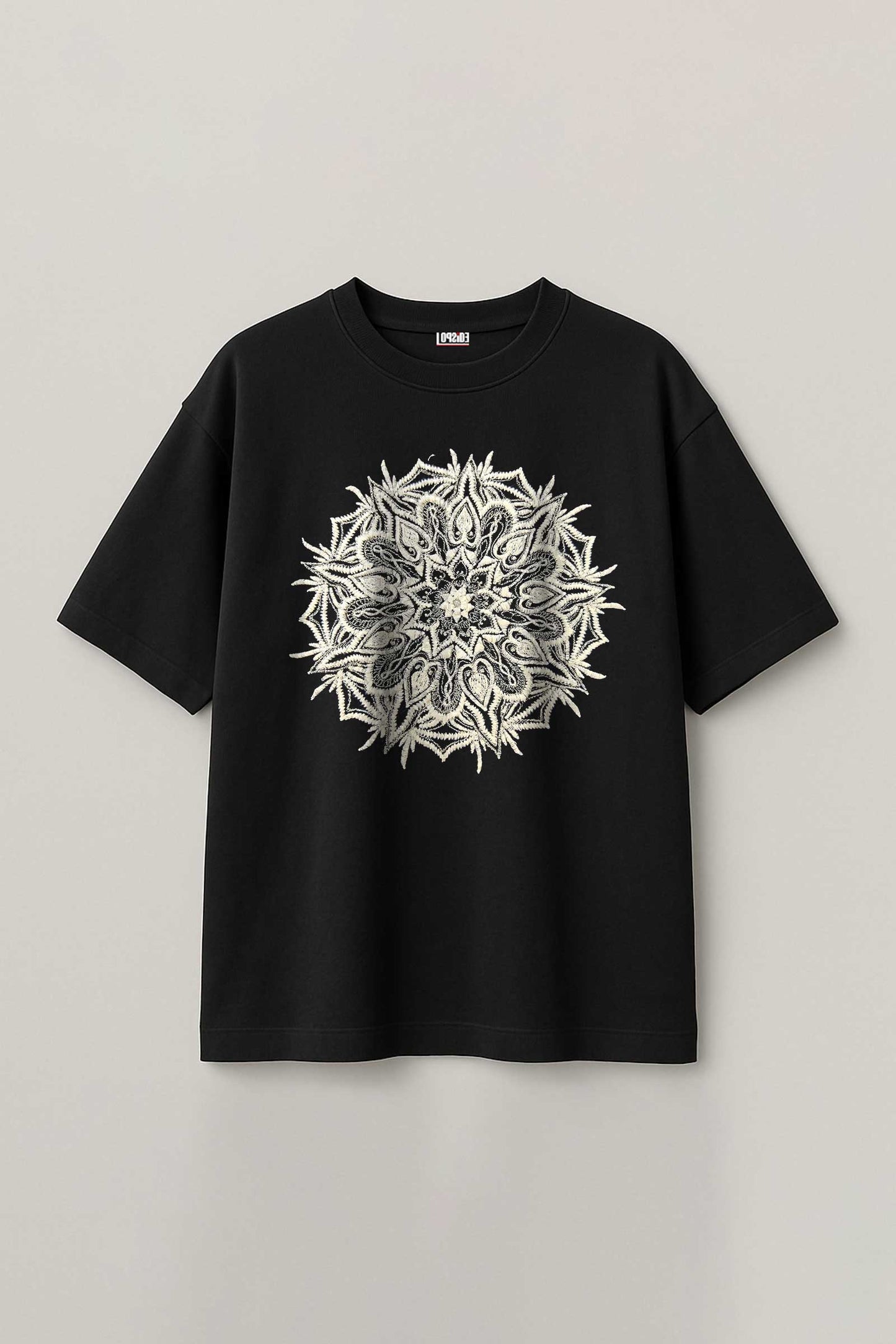 Black t-shirt with a white floral design on a light gray background