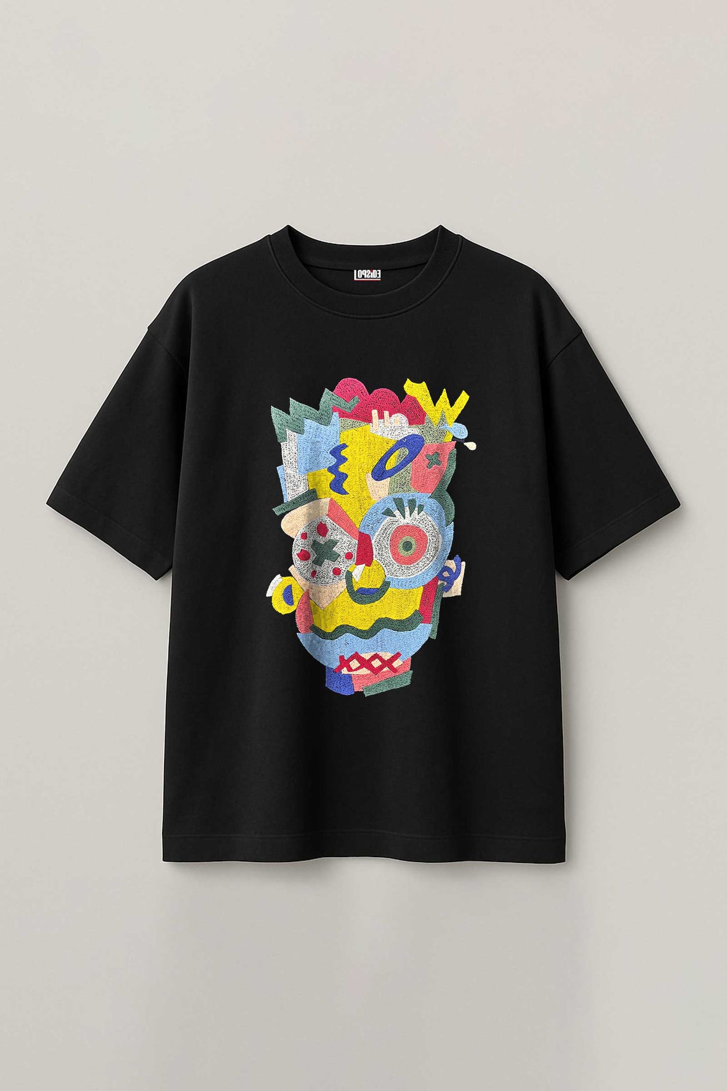 Black t-shirt with colorful abstract design on a light gray background