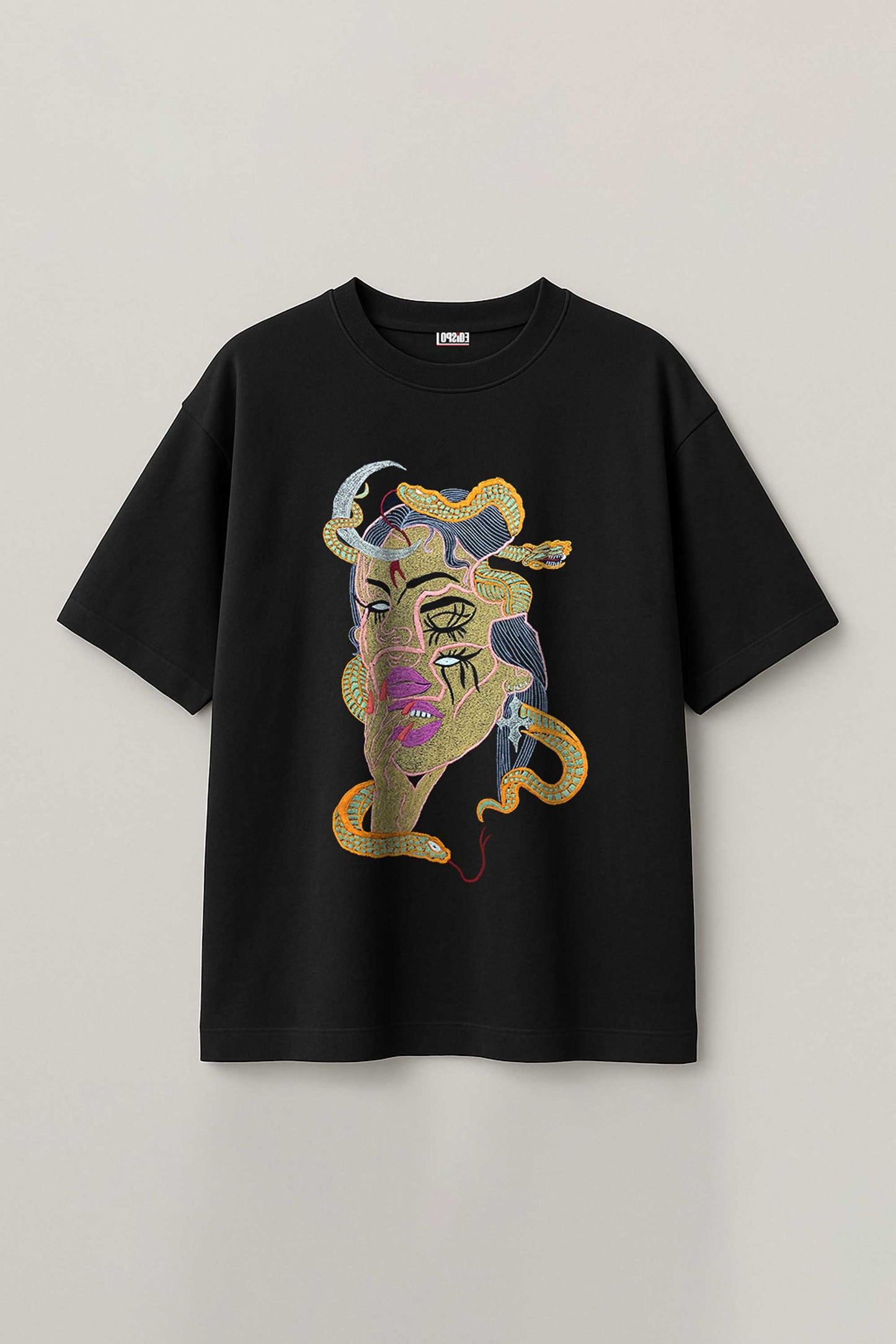 Black t-shirt with colorful embroidery design on a light gray background