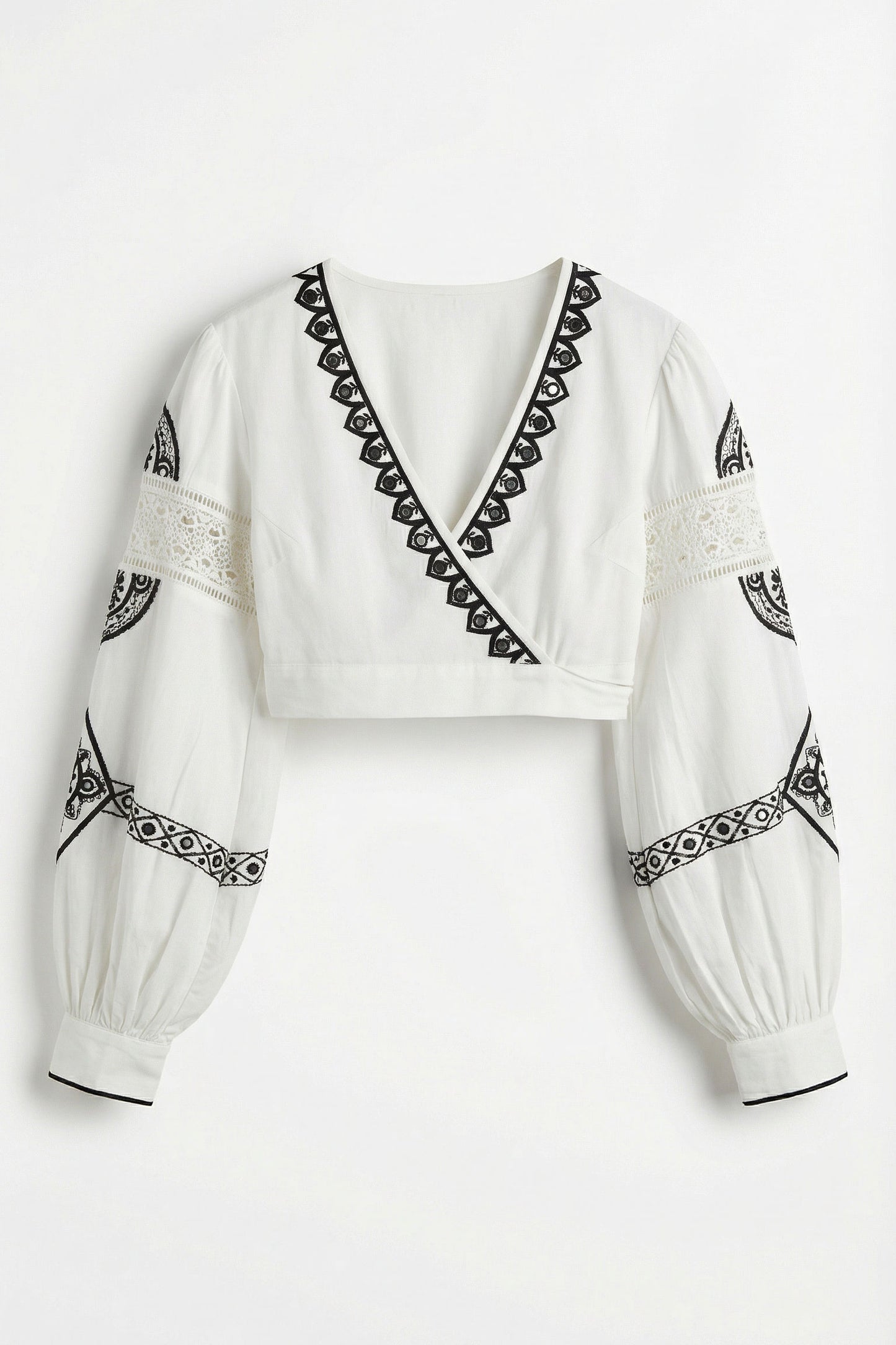 White blouse with black embroidery on a white background