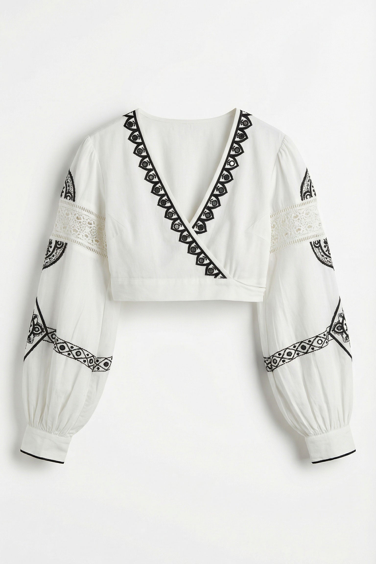 White blouse with black embroidery on a white background