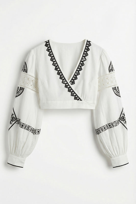 White blouse with black embroidery on a white background