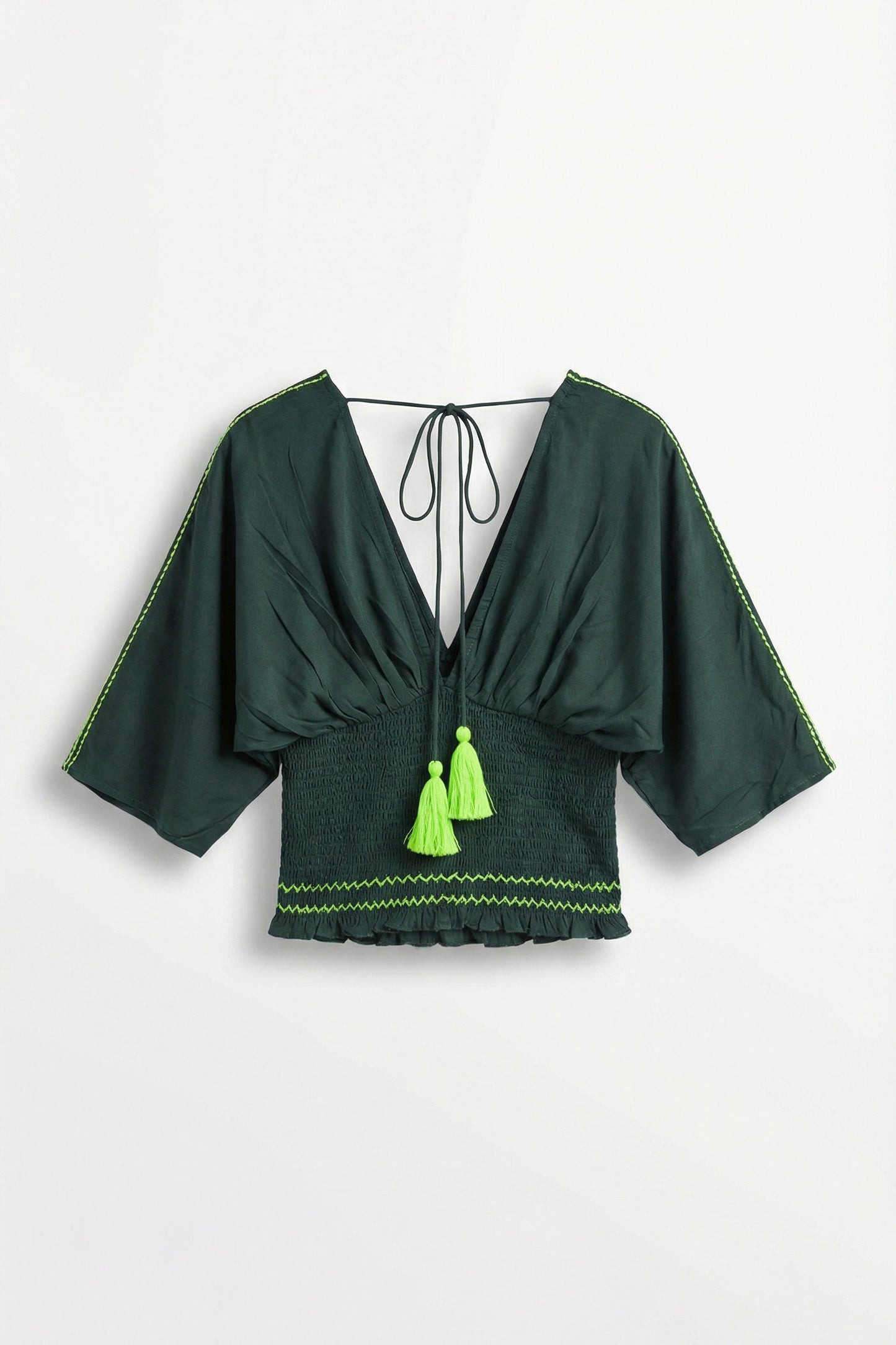 Green top with tassels on a white background
