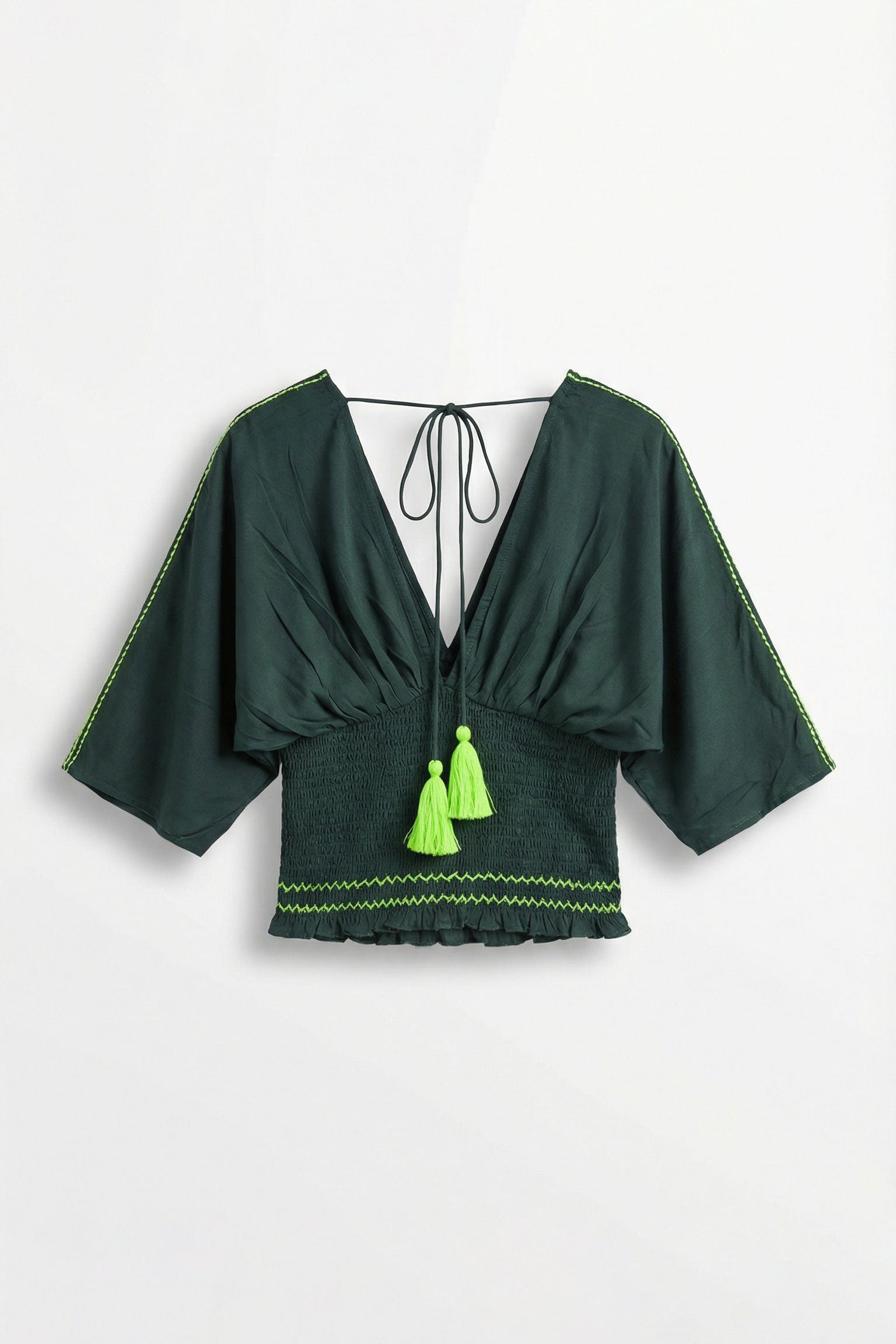 Green top with tassels on a white background