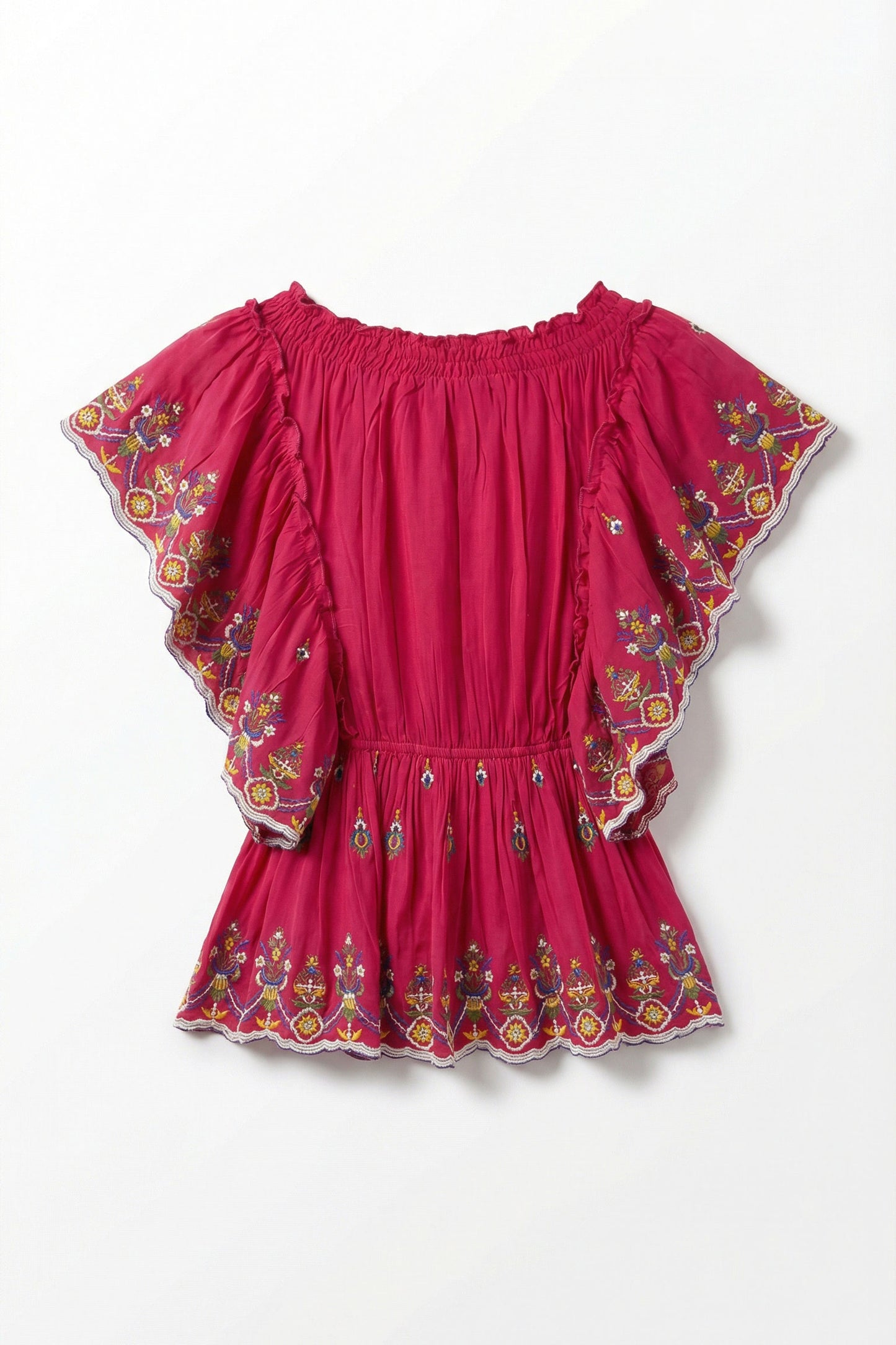 Pink top with floral embroidery on a white background