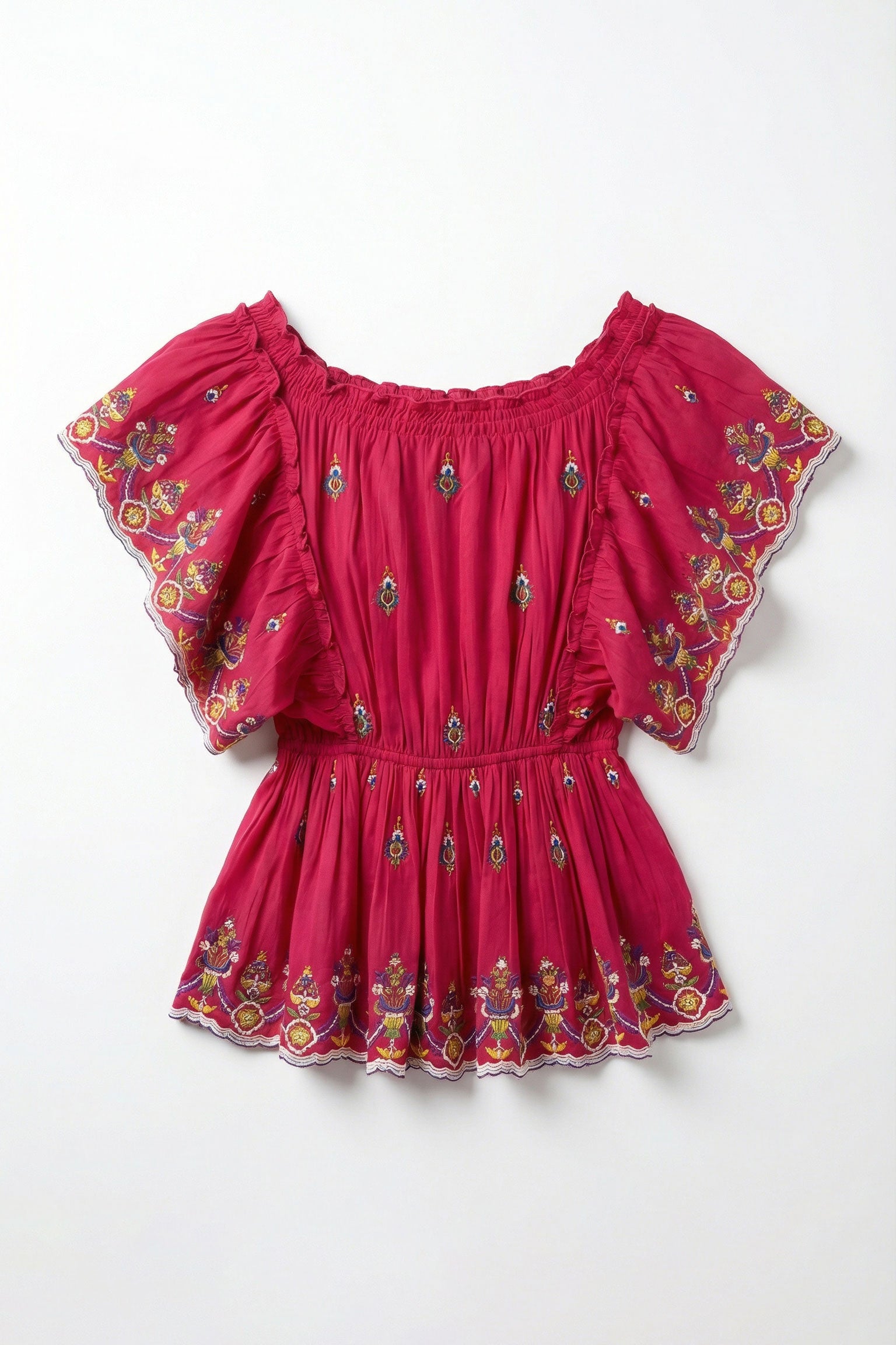 Red top with floral embroidery on a white background