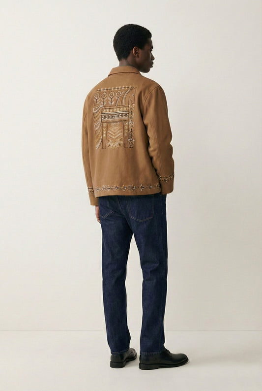 Man wearing a brown jacket with patterned back design on a white background