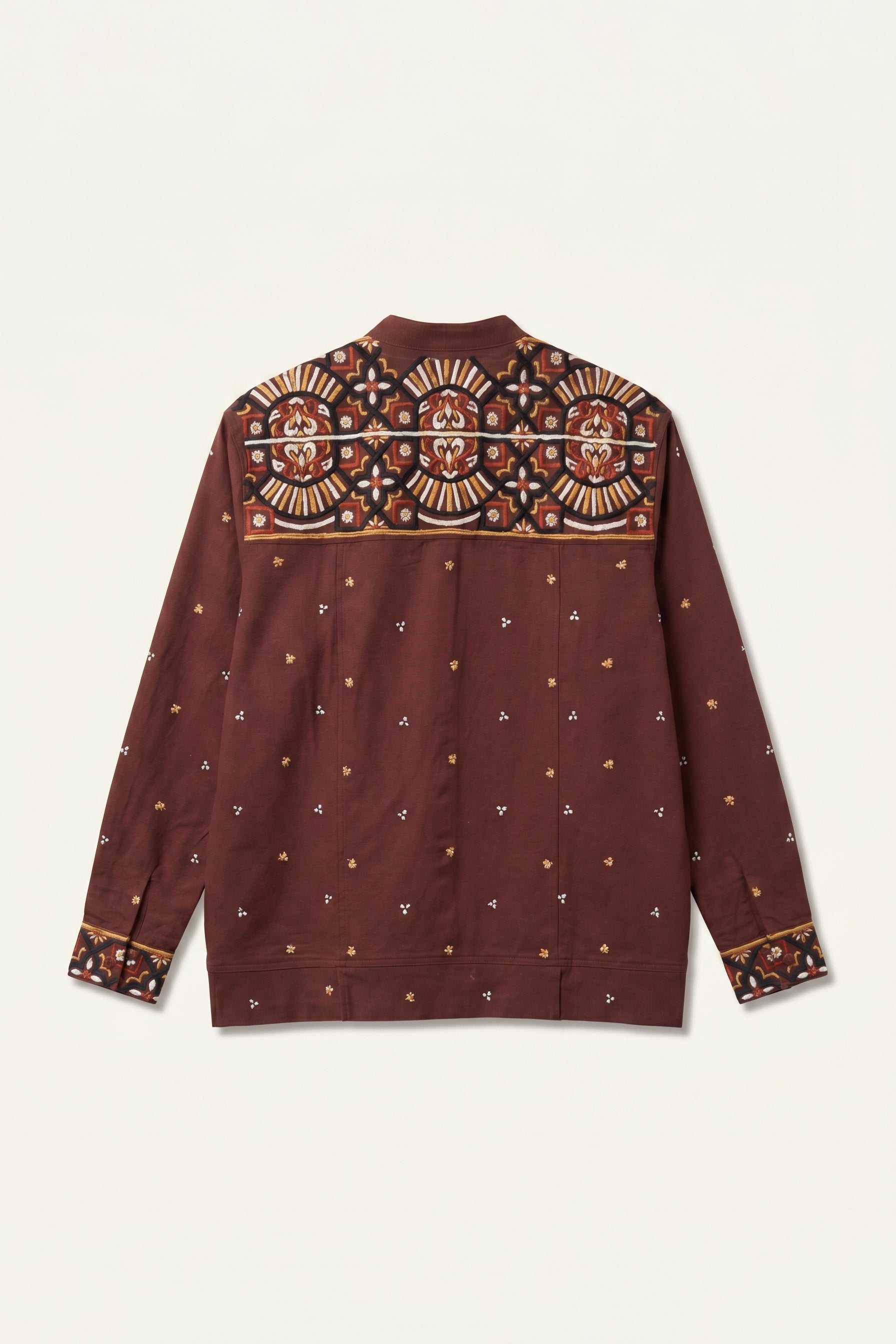 Maroon shirt with intricate patterns on a beige background
