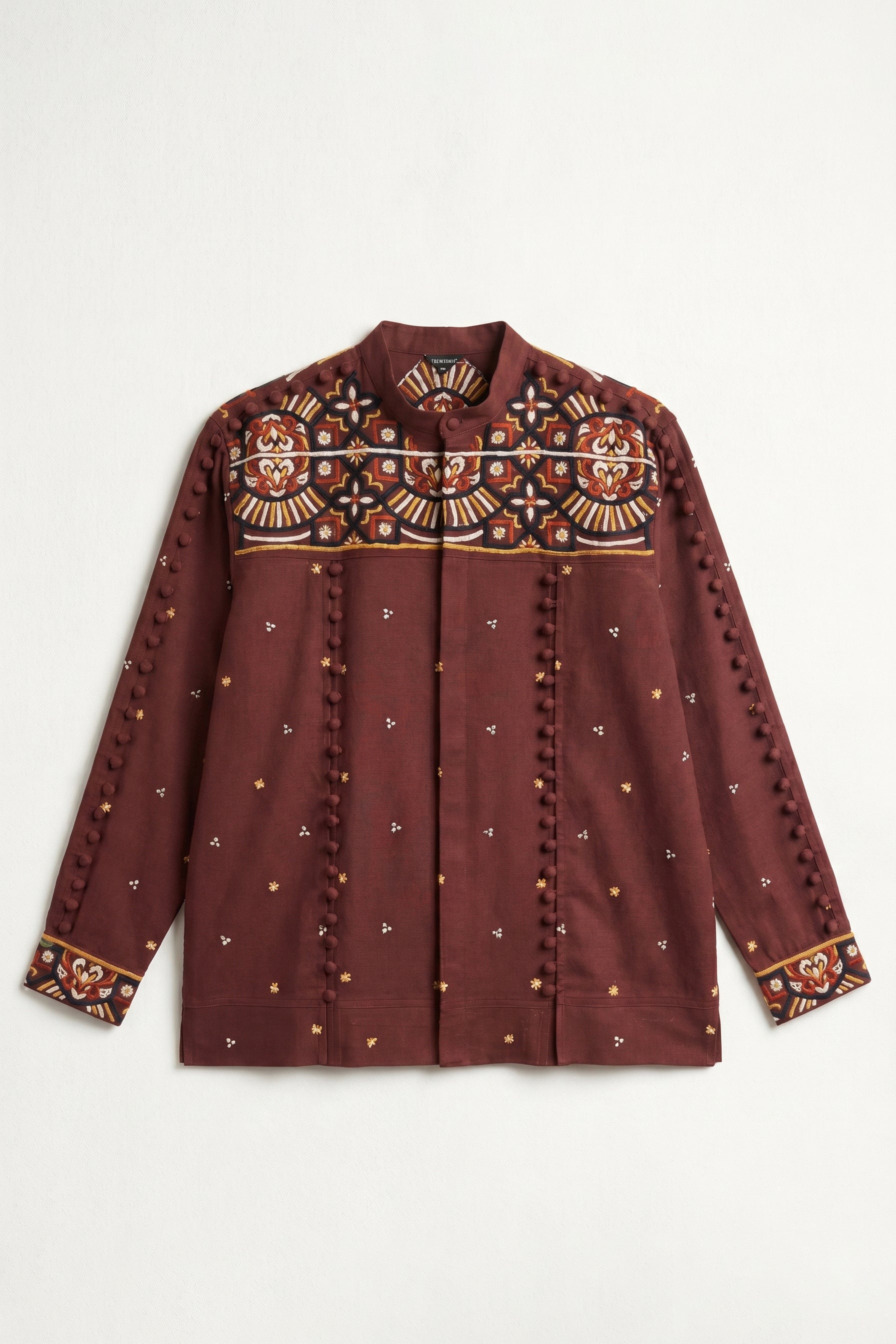Maroon embroidered shirt on a white background