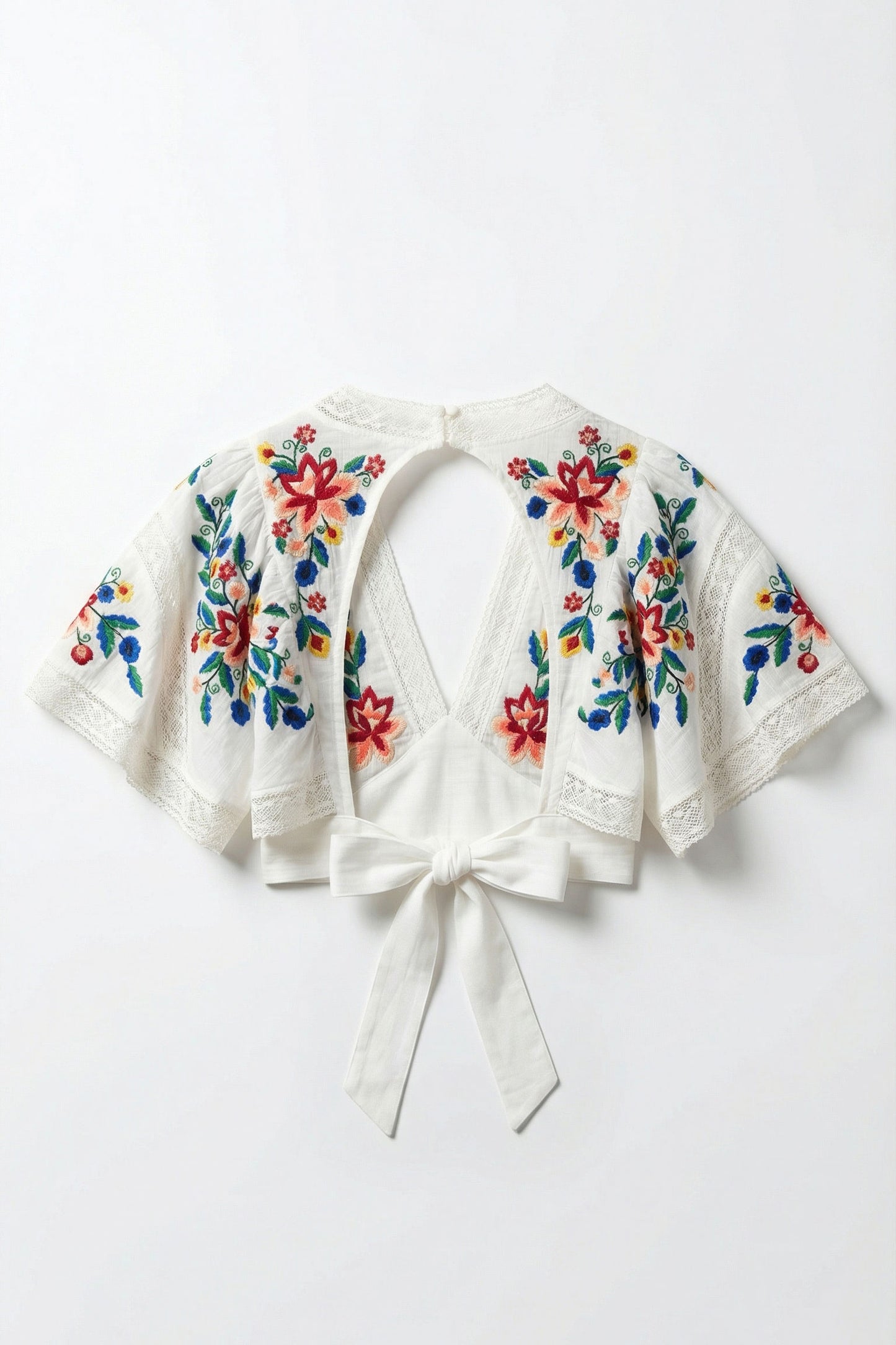 White embroidered jacket with colorful floral patterns on a white background