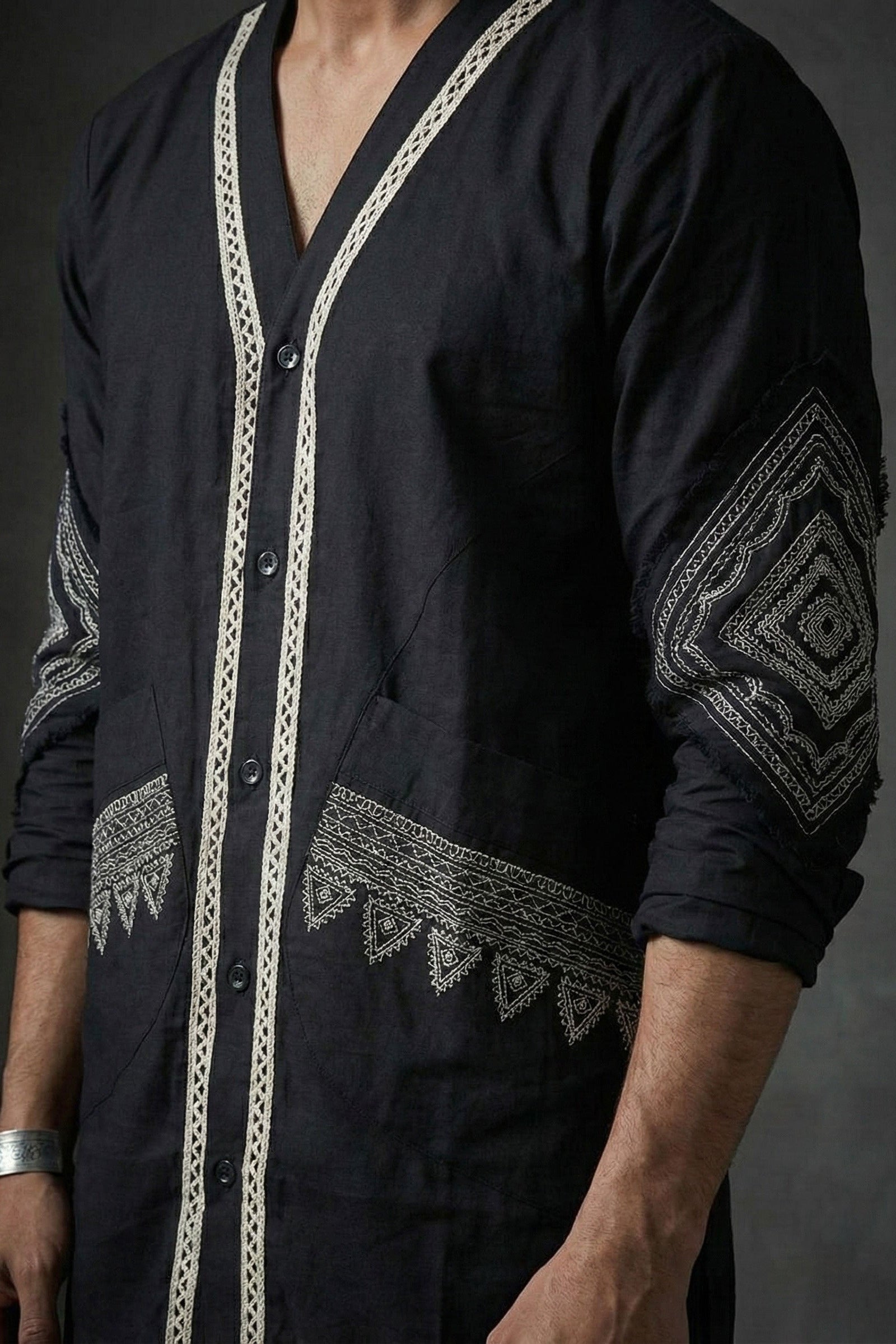 Black Shirt with ecru embroidery on a dark background