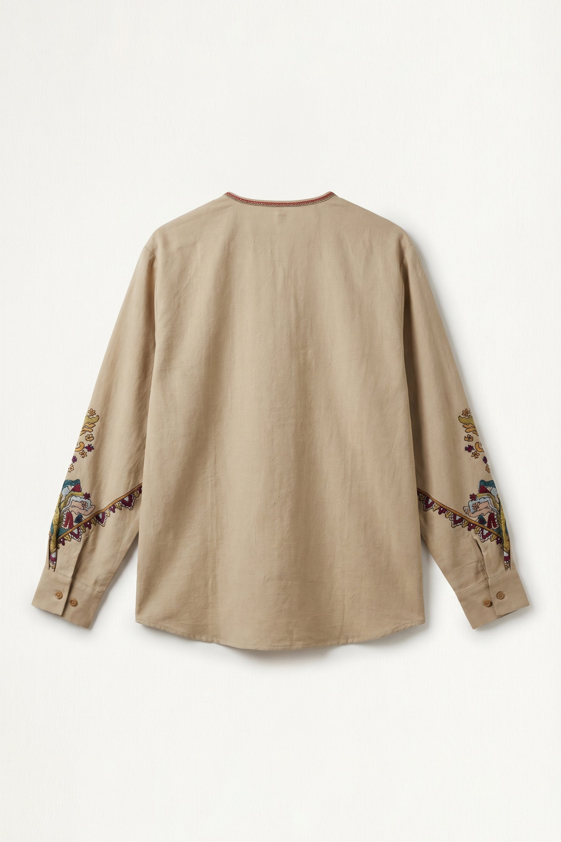 Beige long-sleeve shirt with embroidery on sleeves against a white background