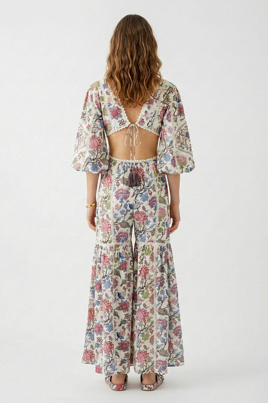 Woman wearing a floral jumpsuit on a white background