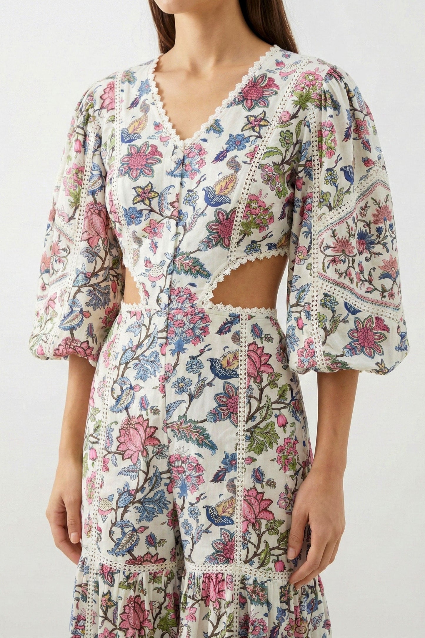 Woman wearing a floral dress with a white background