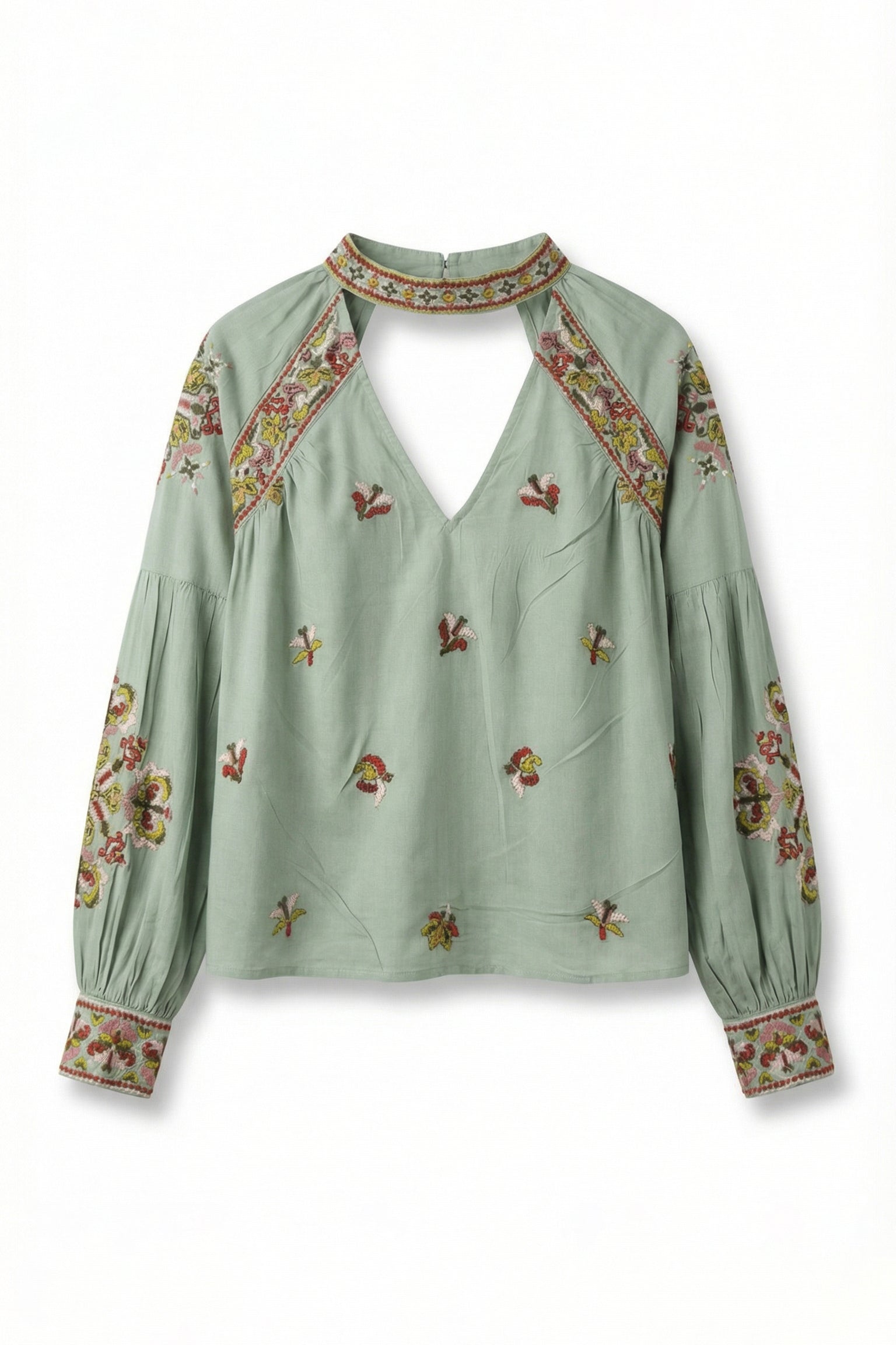 Green blouse with floral embroidery on a white background