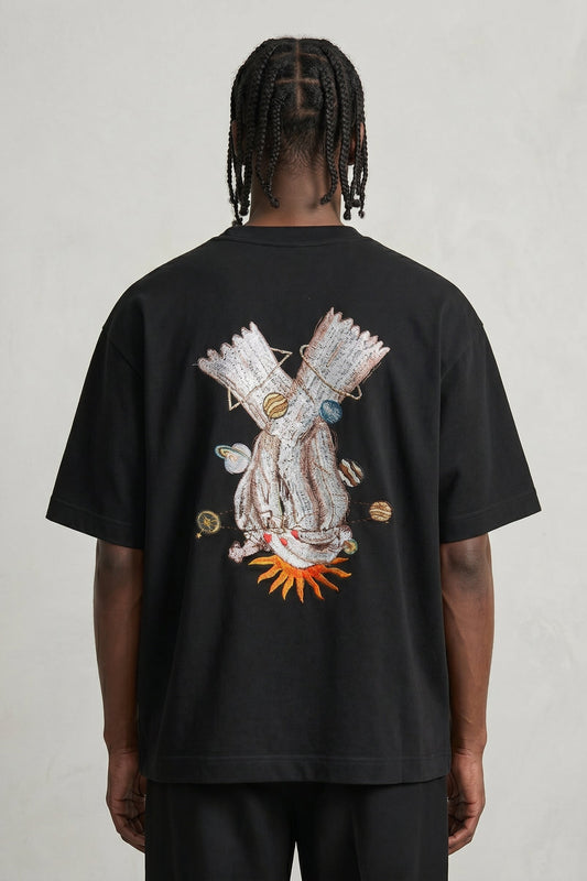 Person wearing a black t-shirt with a colorful graphic on the back against a plain background