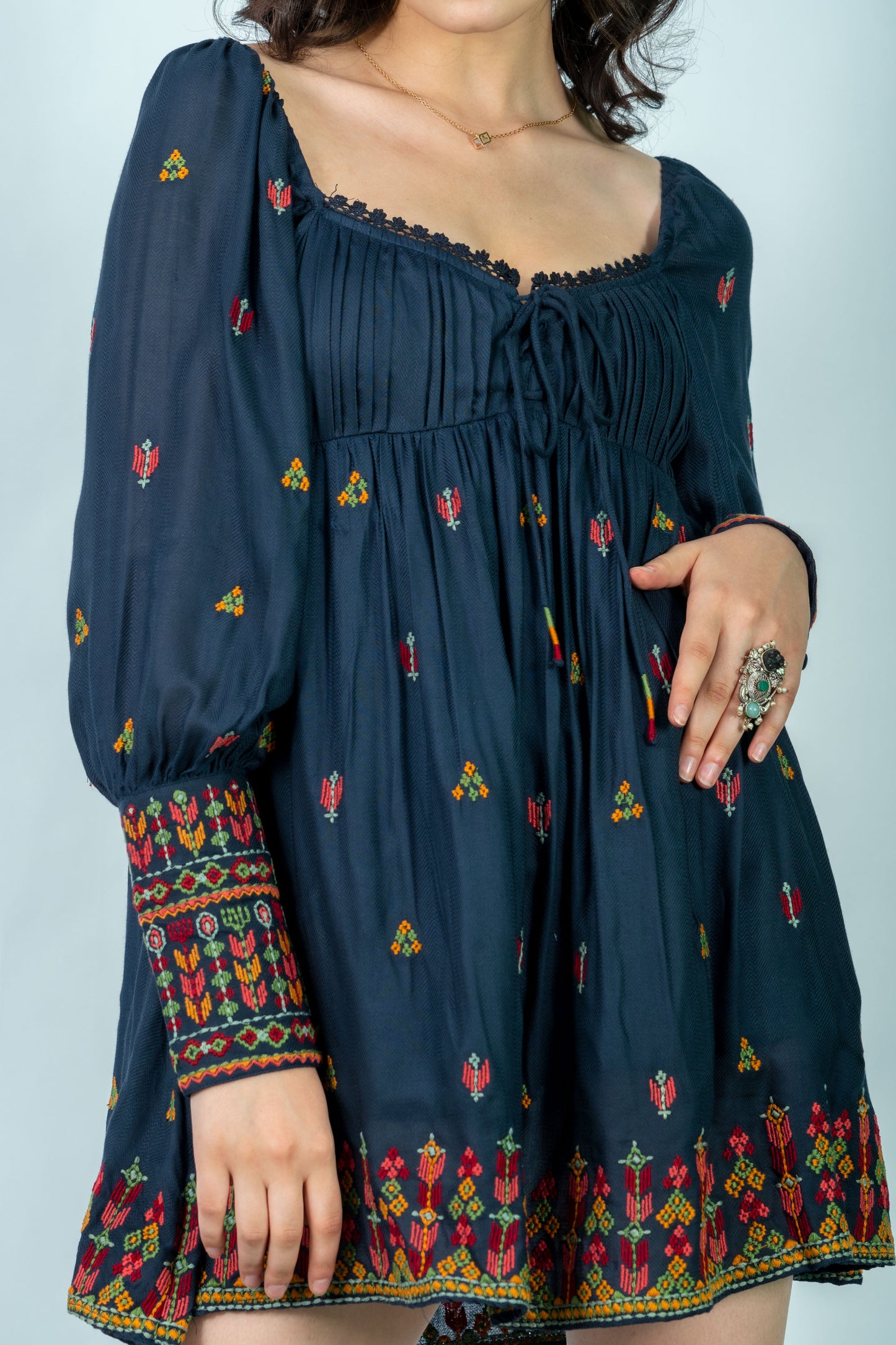 Navy blue dress with colorful patterns on a plain background