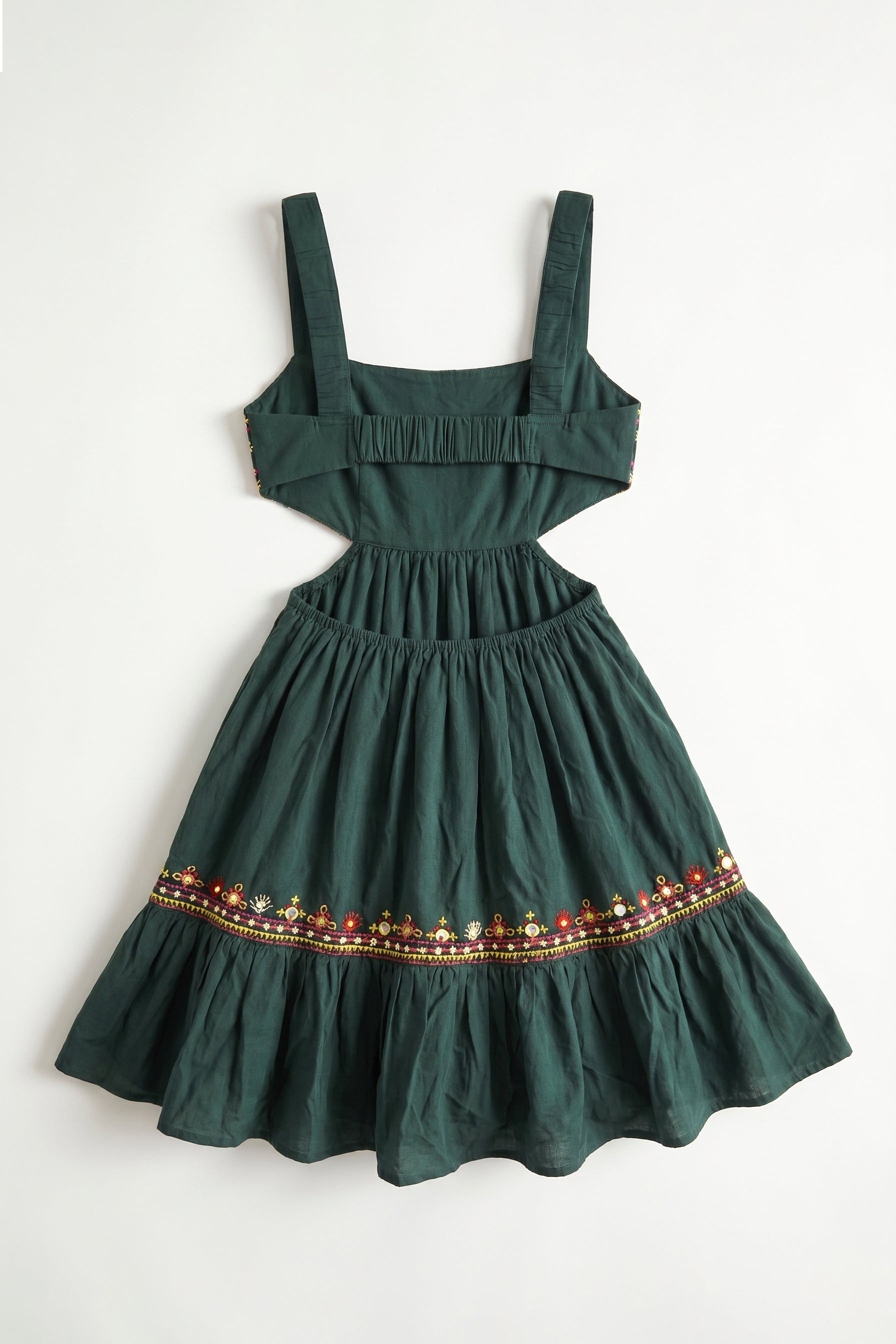 Green dress with decorative hem on a white background