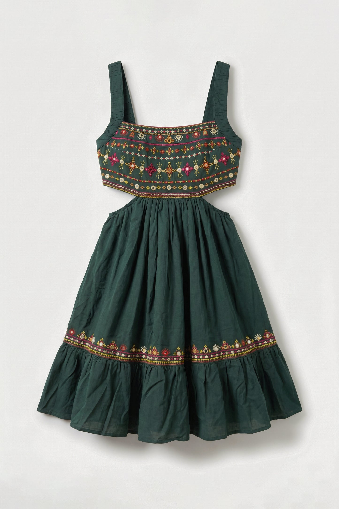 Green dress with embroidered details on a white background