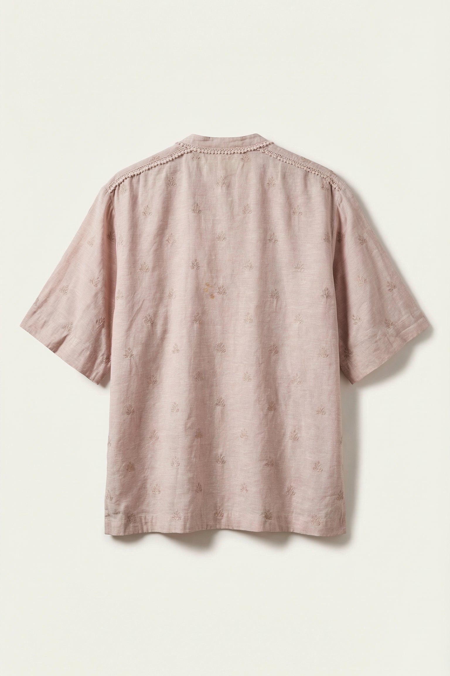 Pink textured shirt on a light beige background