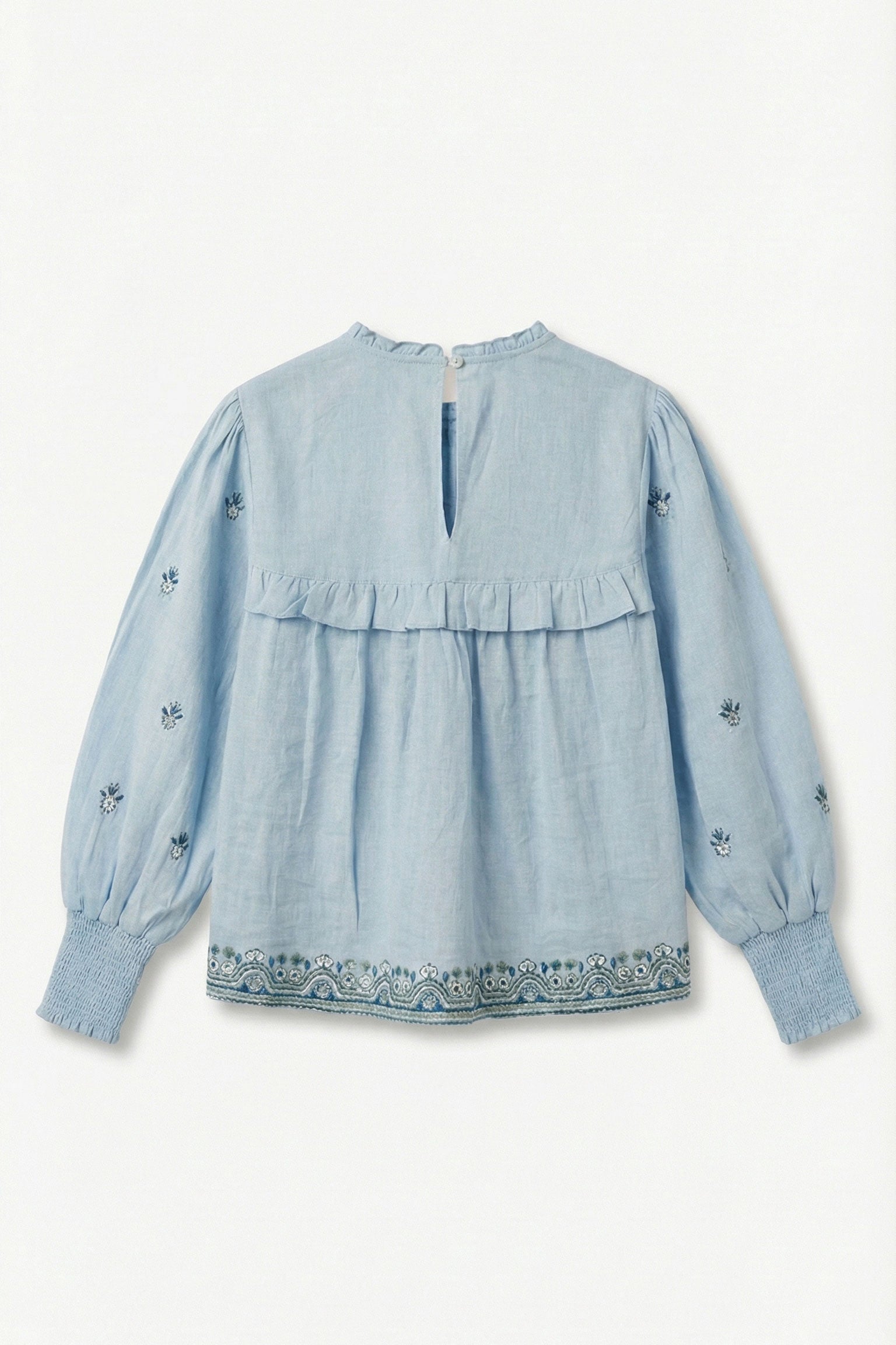 Light blue blouse with floral embroidery on a white background