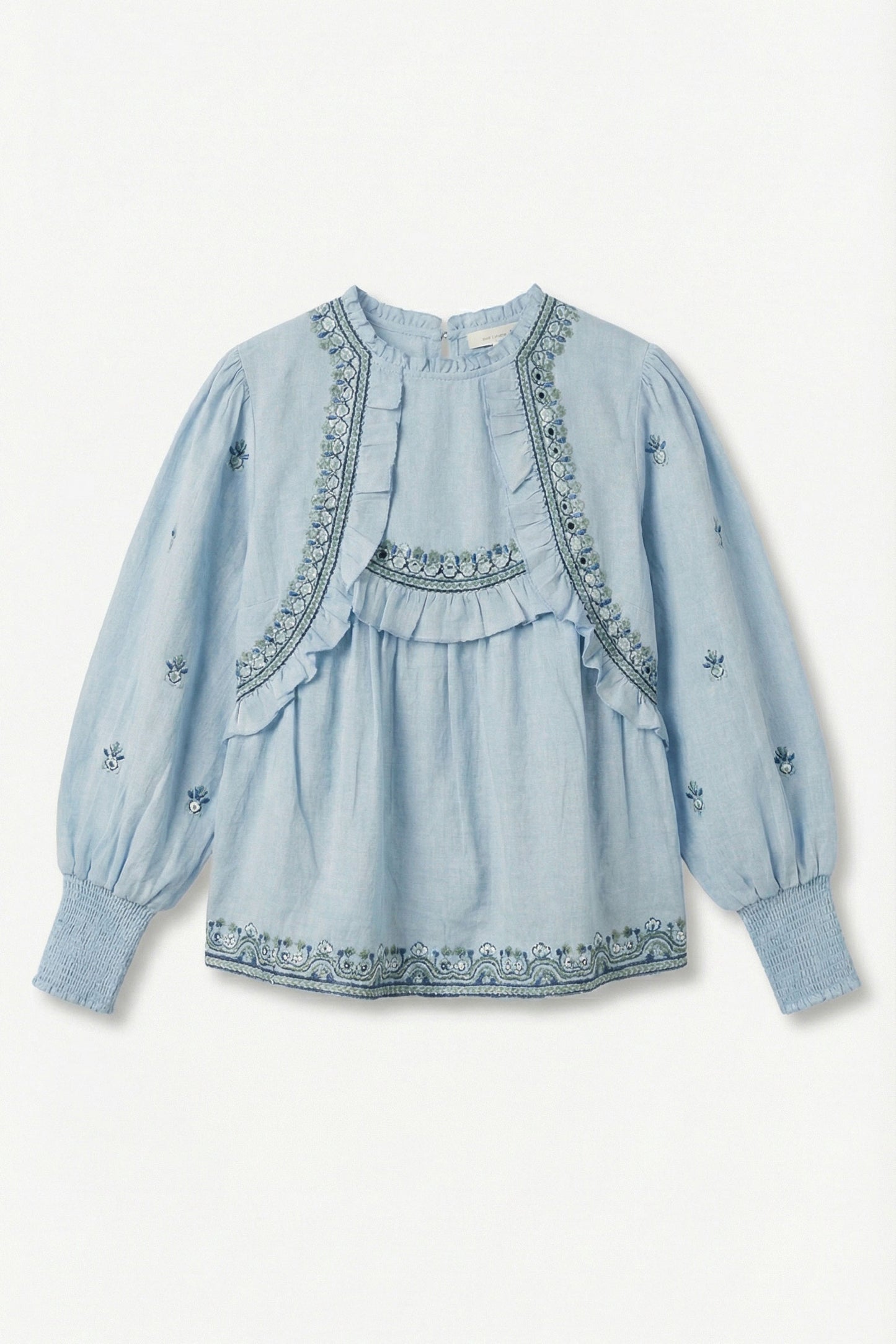 Light blue cotton top with embroidery on a white background