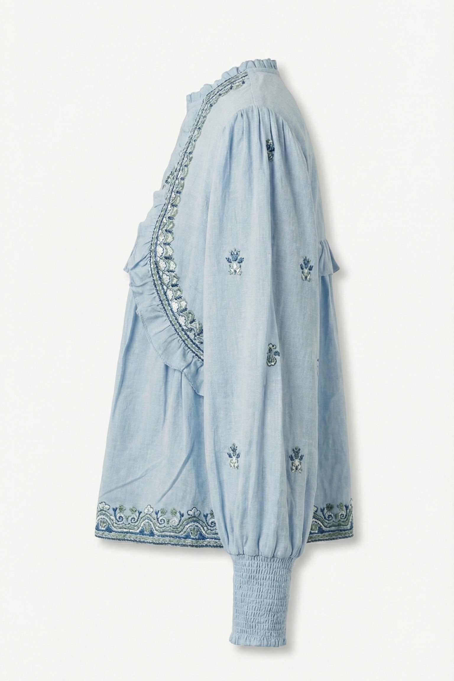 Light blue dress with intricate embroidery on a white background