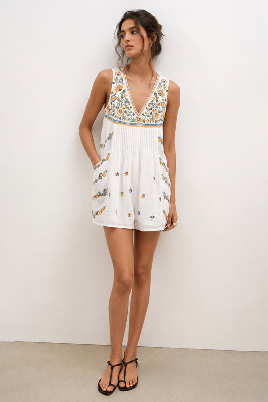 Short white romper for ladies with floral embroidery.